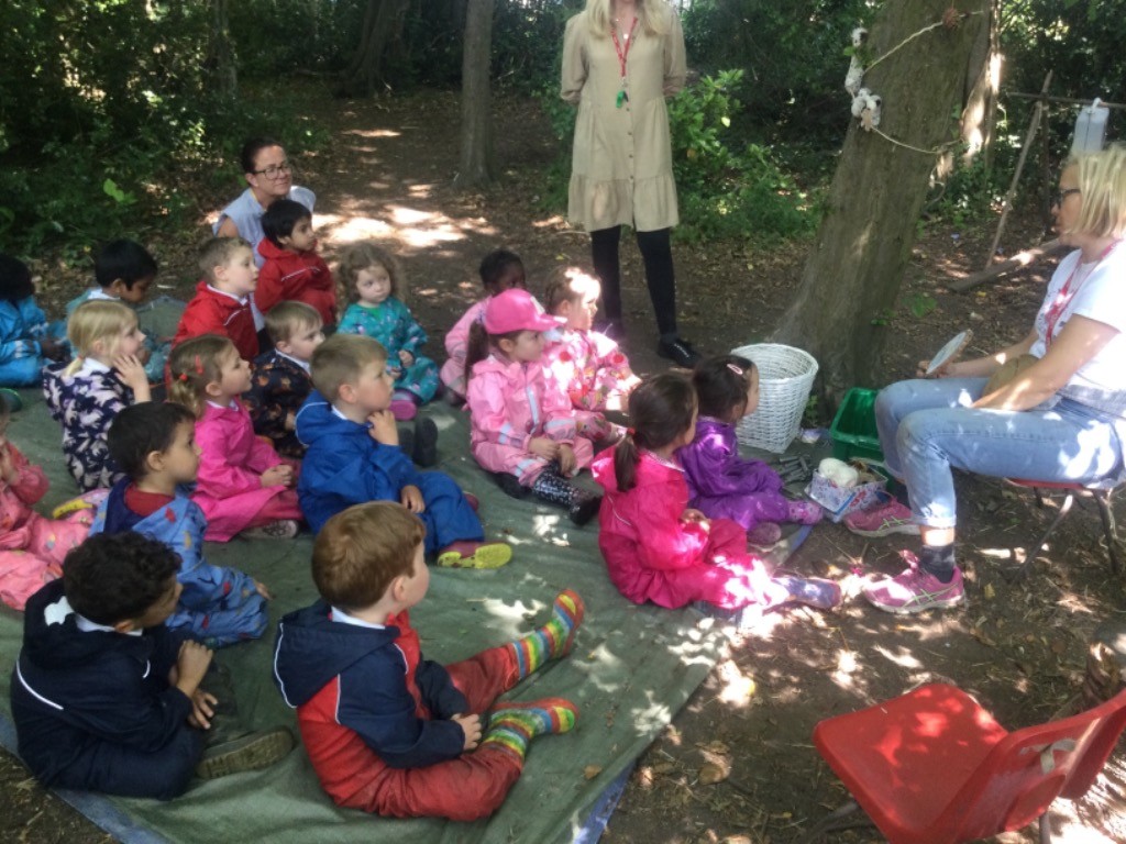 Donna the Ranger leads a session in the Forest School area to a group of Nursery pupils.