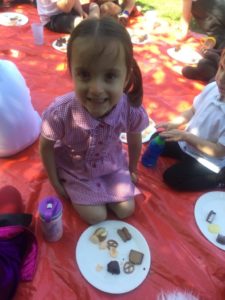 A young girl from the Nursery can be seen eating party food at a Picnic to celebrate the Queen's Platinum Jubilee.
