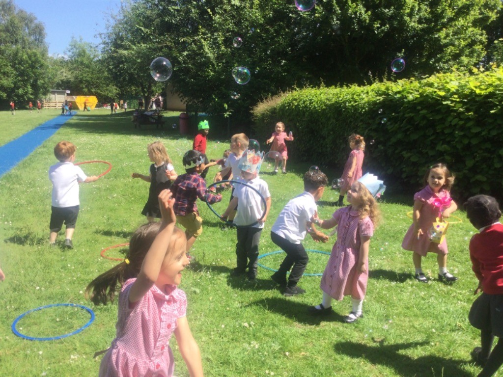 Nursery pupils can be seen playing with one another on the school grounds in celebration of the Queen's Platinum Jubilee.