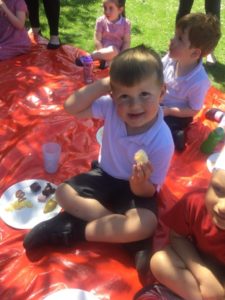 A young boy from the Nursery is seen eating at a Picnic in celebration of the Queen's Platinum Jubilee.