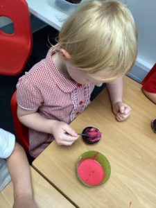Nursery pupils are seen making cakes and cookies as part of Enterprise Week.